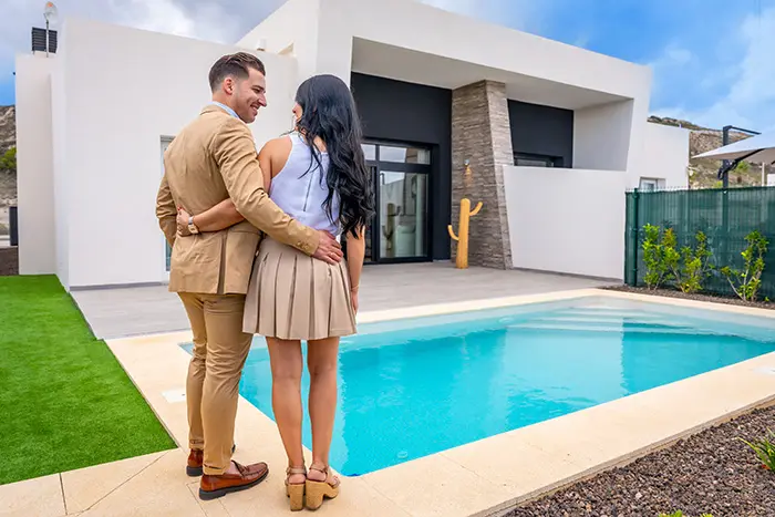 A couple by the pool of a new villa on the Costa Blanca